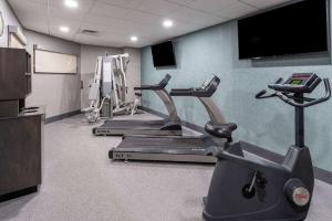 a gym with cardio machines and a flat screen tv at Wingate by Wyndham Vineland in Vineland
