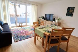 a living room with a table and chairs and a television at Modern Apartment, central in Bad Aibling in Bad Aibling