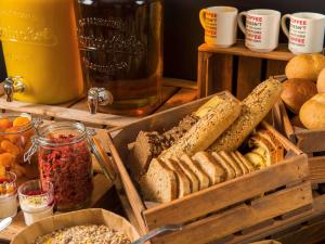 een heleboel verschillende soorten brood op een tafel bij ibis 3 Lacs Neuchâtel in Thielle