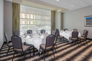a conference room with tables and chairs and a large window at Wyndham Garden Buffalo Downtown in Buffalo