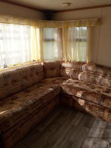 a large couch in a room with a window at domek holenderski in Kołczewo