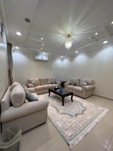 a living room with couches and a coffee table at غايا للشقق المخدومة in Tabuk