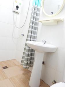 a white bathroom with a sink and a mirror at Lanta Siri Resort in Ko Lanta