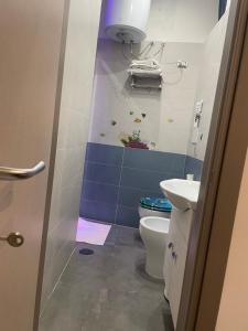 a bathroom with a toilet and a sink at Giulieda in Wonderland in Naples