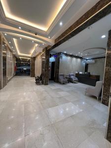 a large lobby with chairs and a reception desk at غايا للشقق المخدومة in Tabuk