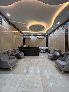a lobby with a waiting room with chairs and a desk at غايا للشقق المخدومة in Tabuk