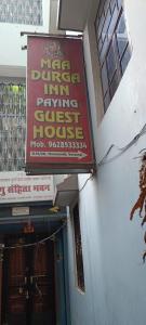 a sign on the side of a building at Maa Durga Inn in Varanasi