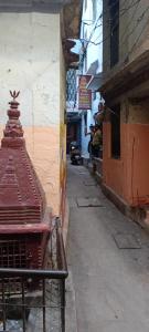 an alley with a red bench on the side of a building at Maa Durga Inn in Varanasi