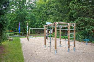 a park with a playground with two swings at Waldhotel & Restaurant Stieglitzenkrug in Feldberg
