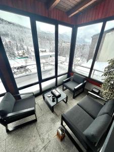 un soggiorno con divani e una grande finestra di Best View Ap with Parking And 2 Bathrooms a Sinaia