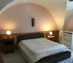 a bedroom with a bed and two night stands and two lamps at Le Rocher des Ducs, vue sur montagne avec parking voiture et motos in Le Glaizil