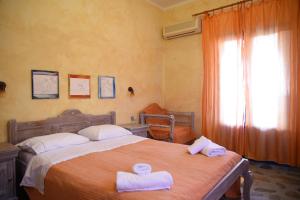 a bedroom with a bed with two towels on it at Elia Studios Amorgos near the sea in Aegiali