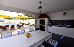 a kitchen and dining room with a table and chairs at Apartments Care in Okrug Donji