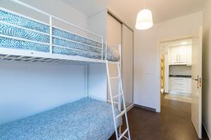 a bedroom with a bunk bed in a room at Precioso piso Torrenueva con Piscina y cerca Playa in Torrenueva +23 photos