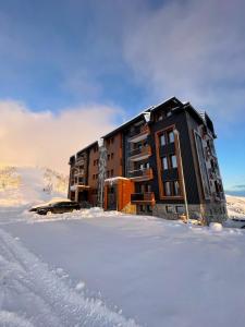 a building in the snow in the snow at Vila Golija in Kopaonik