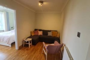 a living room with a couch and a bed at Bright & Lovely & apartment in Whetstone