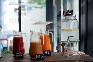 a table with three different types of juice at HOTEL JOHN in Rimini