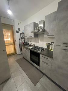 a kitchen with stainless steel appliances and a stove at Sweet Lullaby in Rome
