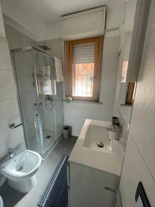 a bathroom with a sink and a shower and a toilet at Sweet Lullaby in Rome