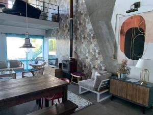 a living room with a wooden table and chairs at Sunrise House Azores - jacuzzi in Senhora da Nazaré
