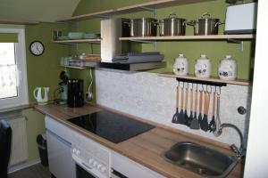 a kitchen with a sink and a counter with utensils at Seehund-Lilly in Wilhelmshaven