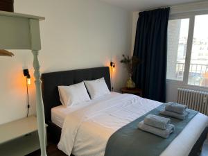a bedroom with a bed with two towels on it at Penthouse Mathilde in Ostend