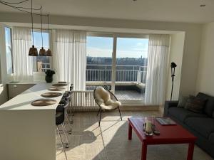 a kitchen and living room with a view of a city at Penthouse Mathilde in Ostend