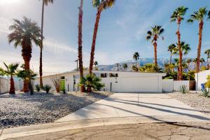 a white house with palm trees and a driveway at Desert Willow Mod Permit# 5268 in Palm Springs