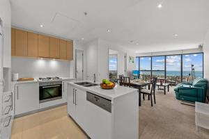 a kitchen and dining room with a view of the ocean at Southbank CBD Apartment with Spectacular Views in Melbourne