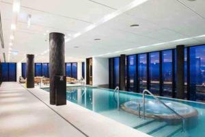 a large pool with a hot tub in a building at Southbank CBD Apartment with Spectacular Views in Melbourne