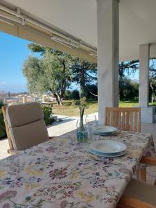 a table with two plates on top of it with a window at Villa Sergio in Bardolino