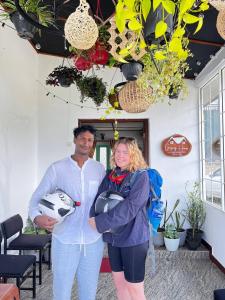 a man and a woman standing in front of a building at Gregory House Hostel in Nuwara Eliya