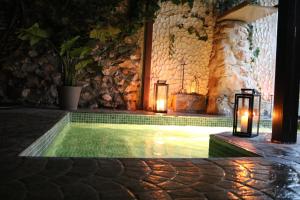 Loranca de TajuñaSpa los Balcones的一座建筑中一座带蜡烛和灯光的游泳池