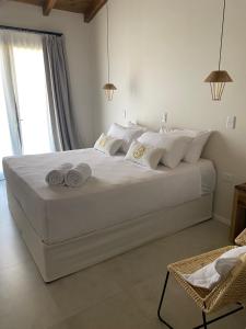 a bedroom with a large white bed with white pillows at Hotel Boutique Miss Olivos in San Rafael +17 photos
