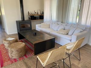 a living room with a white couch and a fireplace at Hotel Boutique Miss Olivos in San Rafael