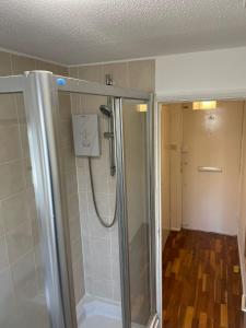 a shower with a glass door in a bathroom at Apartment in Central London Zone 2 in London
