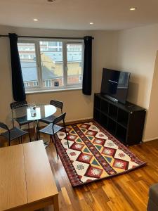 a living room with a table and a rug at Apartment in Central London Zone 2 in London