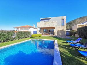 a swimming pool in the yard of a house at Hill & Beach house in Viana do Castelo