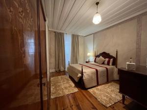 Cama ou camas em um quarto em Alojamento VINTAGE BAIXA - TOMAR