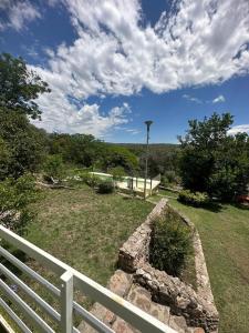 a view of a yard with a white fence at Mi Sueño in San Antonio de Arredondo