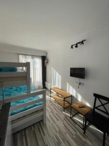 a room with two bunk beds and a flat screen tv at Apartment N503 Gudauri Loft in Gudauri