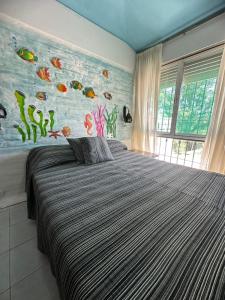 a bedroom with a bed with a fish mural on the wall at Mi Sueño in San Antonio de Arredondo +30 photos
