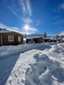a pile of snow in front of a house at Camping Le Miroir in Les Hôpitaux-Neufs