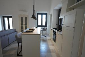 a kitchen with a kitchen island in a room at AMIN - centro storico - appartamento in Polignano a Mare