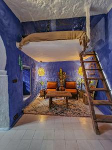 a room with a bunk bed and a ladder at Casa Amina in Chefchaouene