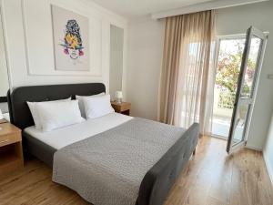 a bedroom with a large bed and a window at Apartments Mrdak in Bar +225 photos