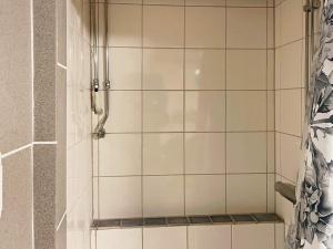 a bathroom with a shower with white tile at Peaceful stay near Orust Forest in Svanesund +16 photos