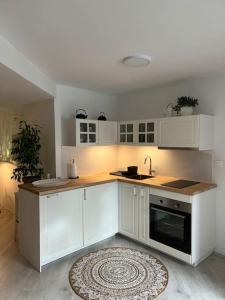 a kitchen with white cabinets and a sink at Wholesome Holiday Base in nature in Gozd Martuljek