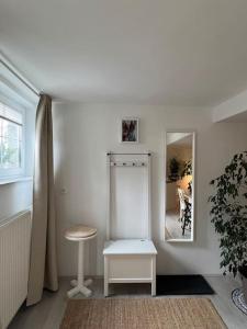 a white room with a stool and a mirror at Wholesome Holiday Base in nature in Gozd Martuljek