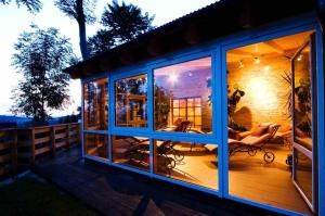 a screened in porch of a house with windows at Panoramahotel Grobauer in Spiegelau